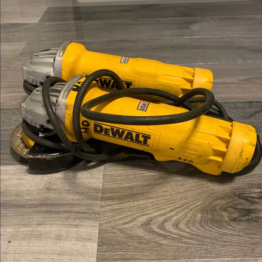 Two 4 in dewalt angle grinders with handles
